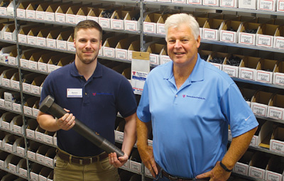 Tacoma Screw Products Wenatchee Branch Manager Aaron Bruun, left, holds a massive bolt in the stores stock room. Next to him is Regional Outside Sales Manager Terry Lally. The store, at 1420 N. Miller St., had a soft opening in early September. 
Gary Bgin/WBJ